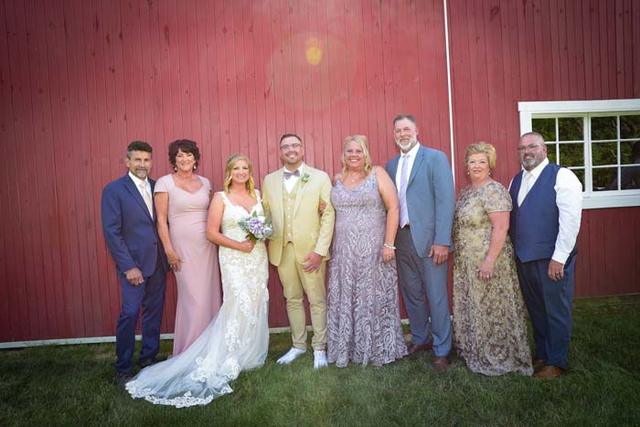 Wedding party in front of the red barn