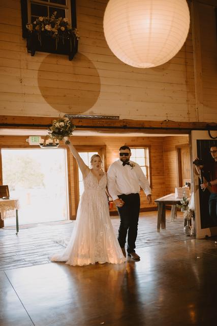 Bride entering the reception in the barn