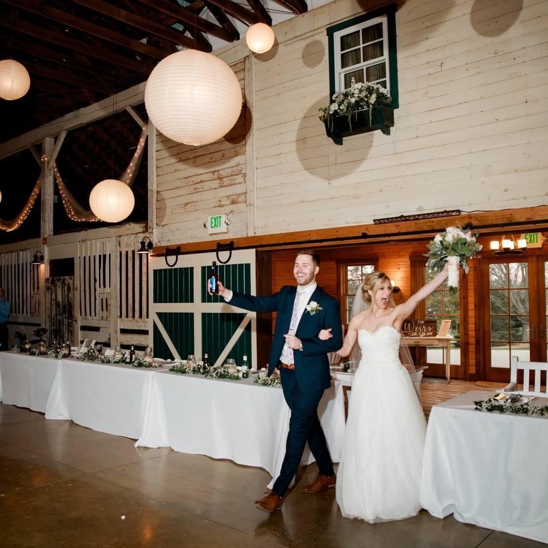 Newlyweds make their grand entrance into the barn reception