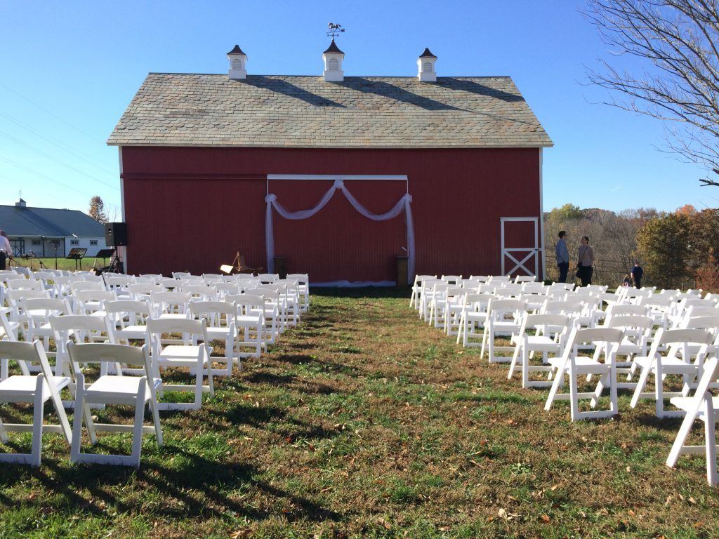 Outdoor ceremony in front of the little red barn