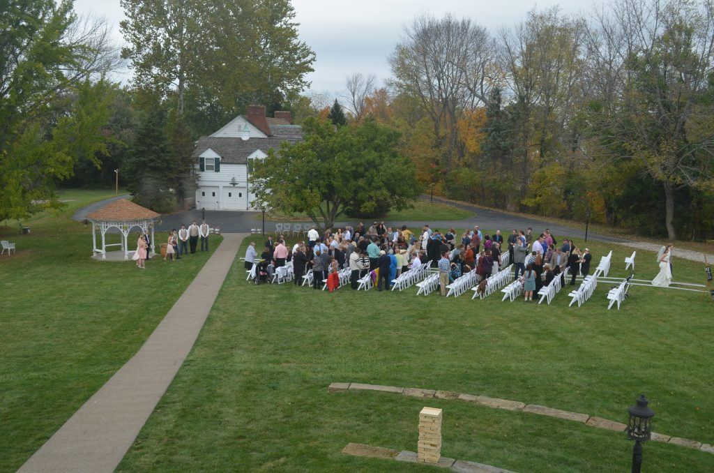 Lawn ceremony beside the white gazebo