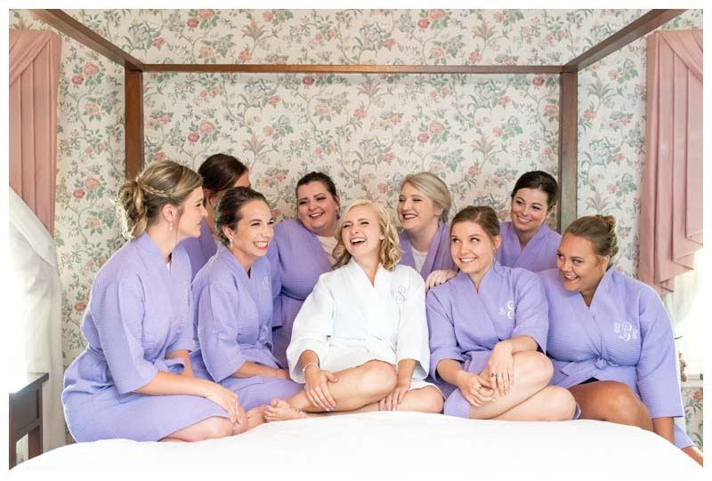 Bridesmaids in matching robes in a house bedroom
